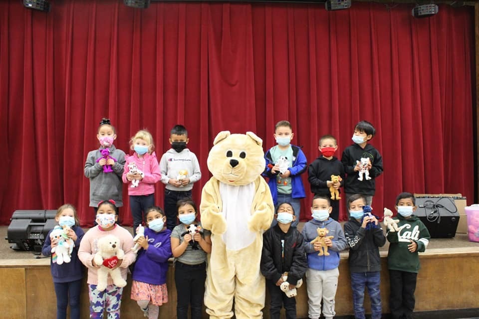 students receiving stuffed animals